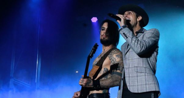 Moment lead singer of iconic rock band Janes Addiction punches guitarist mid-song on stage